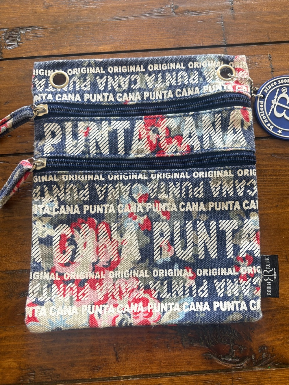 Robin Ruth Navy Canvas Crossbody with White Text and Red Floral Accents